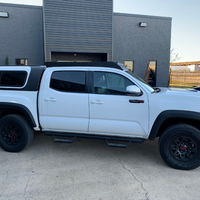 Full passenger side view of Economy Roof Rack from on a white Toyota Tacoma - Cali Raised LED