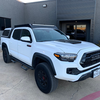Front passenger view of white Toyota Tacoma with Economy Roof Rack - Cali Raised LED