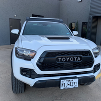 Front view of Economy Roof Rack on a white Toyota Tacoma - Cali Raised LED