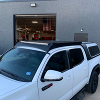 Front right view of Economy Roof rack on a white Toyota Tacoma - Cali Raised LED
