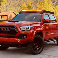Front view of Economy Roof Rack with amber light baron a red Toyota Tacoma - Cali Raised LED