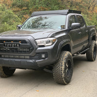 Front drivers side view of gray Toyota Tacoma with Premium roof rack - Cali Raised LED