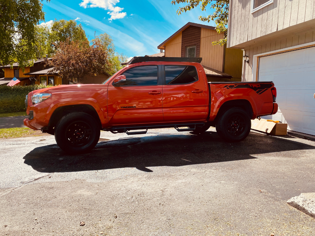 Side view of Economy Roof Rack with amber light baron a red Toyota Tacoma - Cali Raised LED