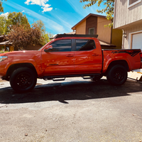 Side view of Economy Roof Rack with amber light baron a red Toyota Tacoma - Cali Raised LED