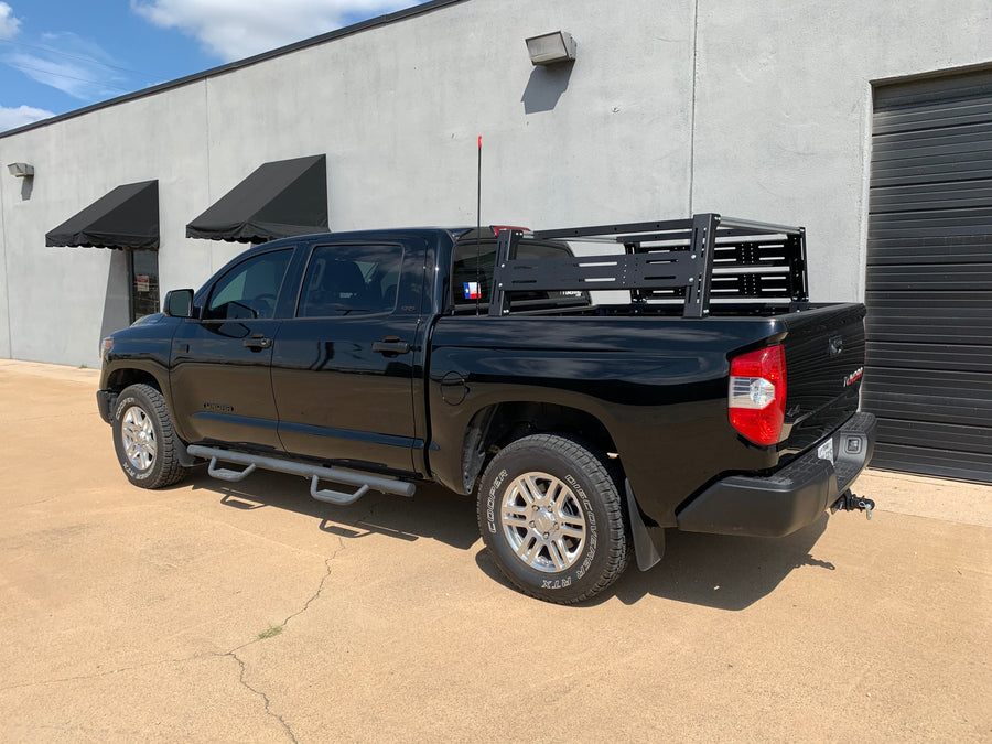 Rear drivers side view of black Toyota Tundra with Overland Bed Rack - Cali Raised LED