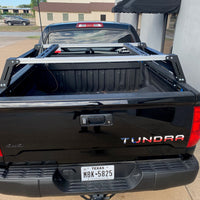 Rear view of black Toyota Tundra with Overland Bed Rack - Cali Raised LED