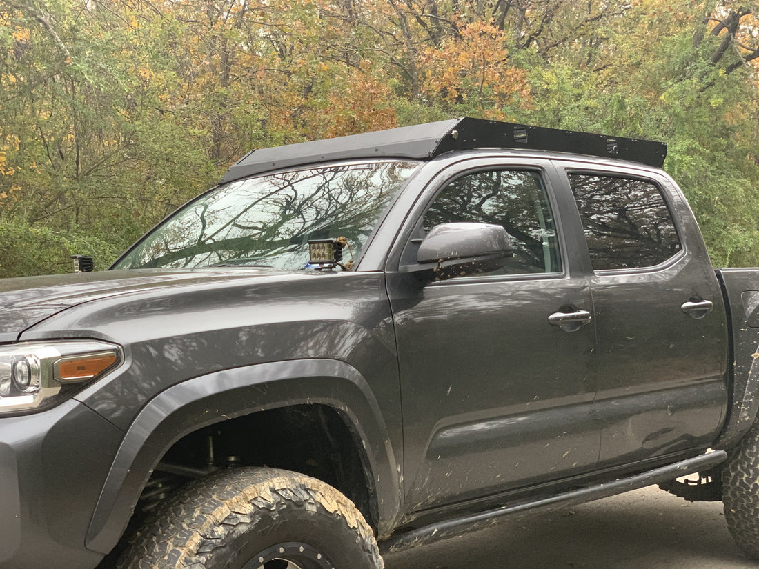 Front drivers side view of gray Toyota Tacoma with Premium roof rack - Cali Raised LED