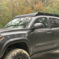 Front drivers side view of gray Toyota Tacoma with Premium roof rack - Cali Raised LED