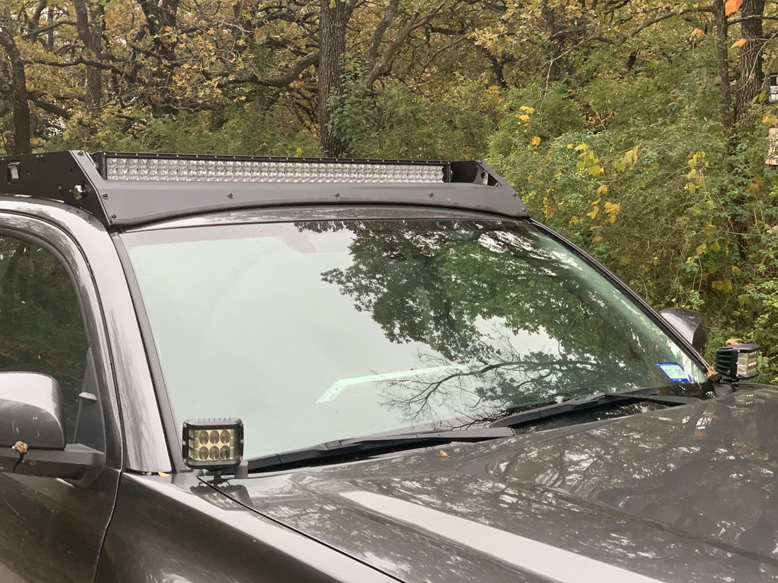 Front view of gray Toyota Tacoma with Premium Roof Rack with exposed light bar- Cali Raised LED