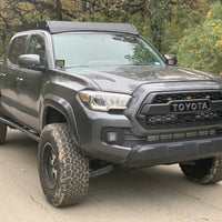 Front passengers side view of gray Toyota Tacoma with Premium roof rack - Cali Raised LED