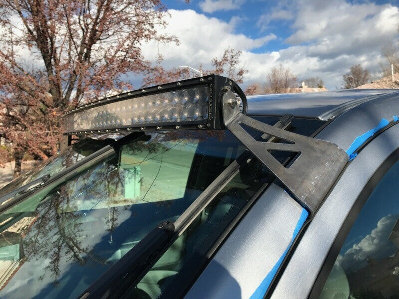 Curved LED light bar and roof mounting brackets on gray Toyota Tundra - Cali Raised LED