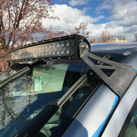 Curved LED light bar and roof mounting brackets on gray Toyota Tundra - Cali Raised LED